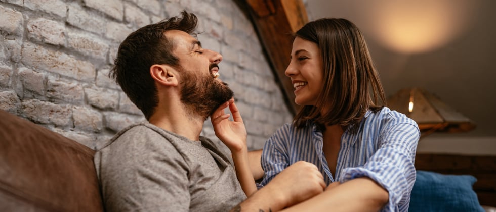 A man and a woman laughing at each other, showing some clear love languages.