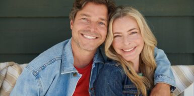 Woman and man over 50 smiling into camera as a couple