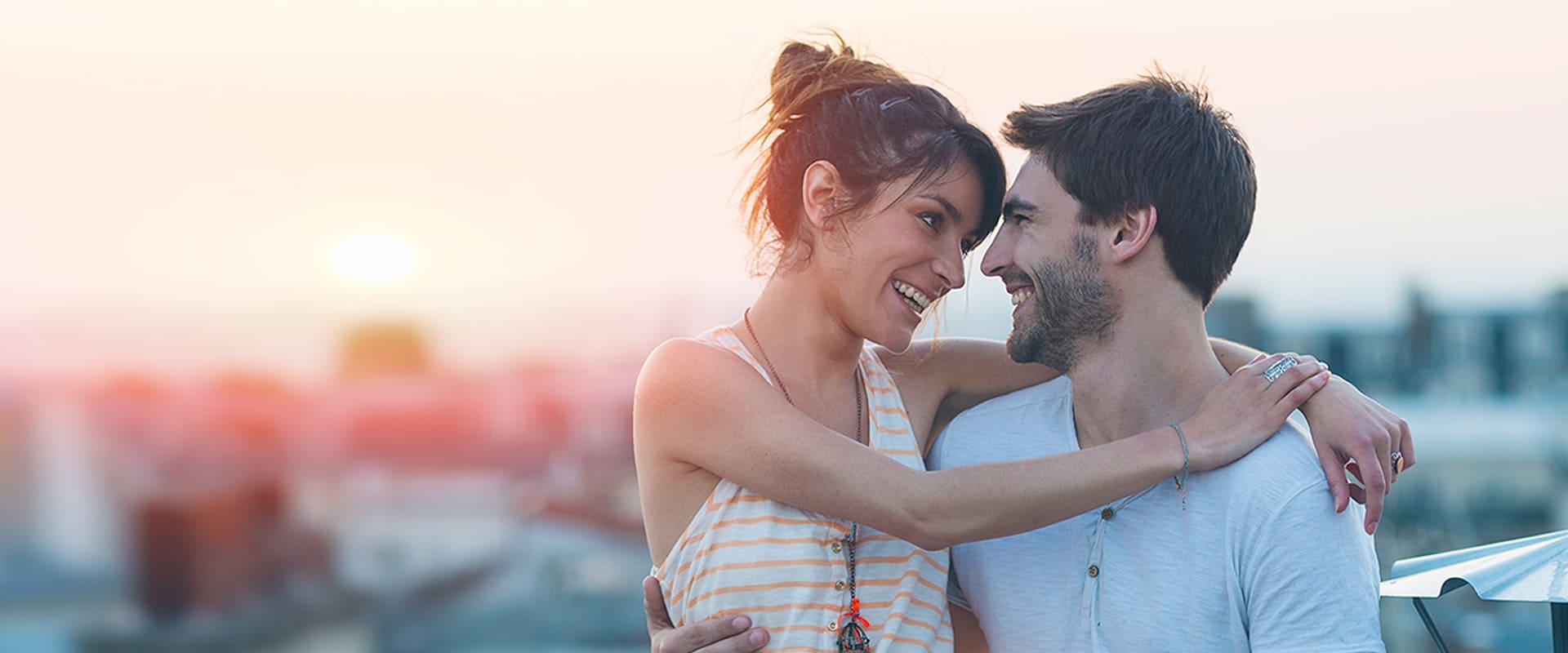 Dating over 30 symbolized by a couplewho smile at each other and embrace