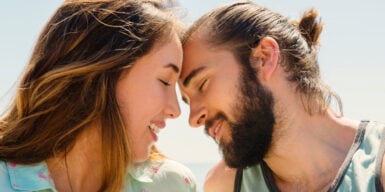 A woman and a man touching their foreheads, initiating physical touch as love language