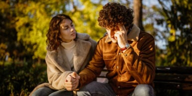 a couple sitting, holding hands