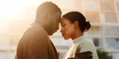 A woman and man leaning their forheads at each other, symbolizing "how to make someone fall in love with you"