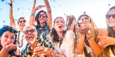 A group of people having fun at a party & throwing confetti