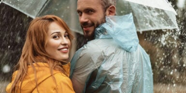 Couple caught in the rain under an umbrella together